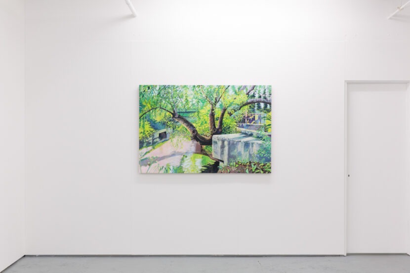 A colourful illustration of a tree being displayed on a white wall next to a door