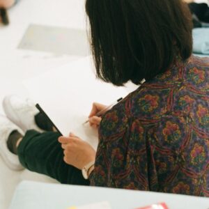 a photo of someone doodling, taken from behind them