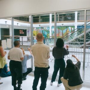 A group of people writing on a window