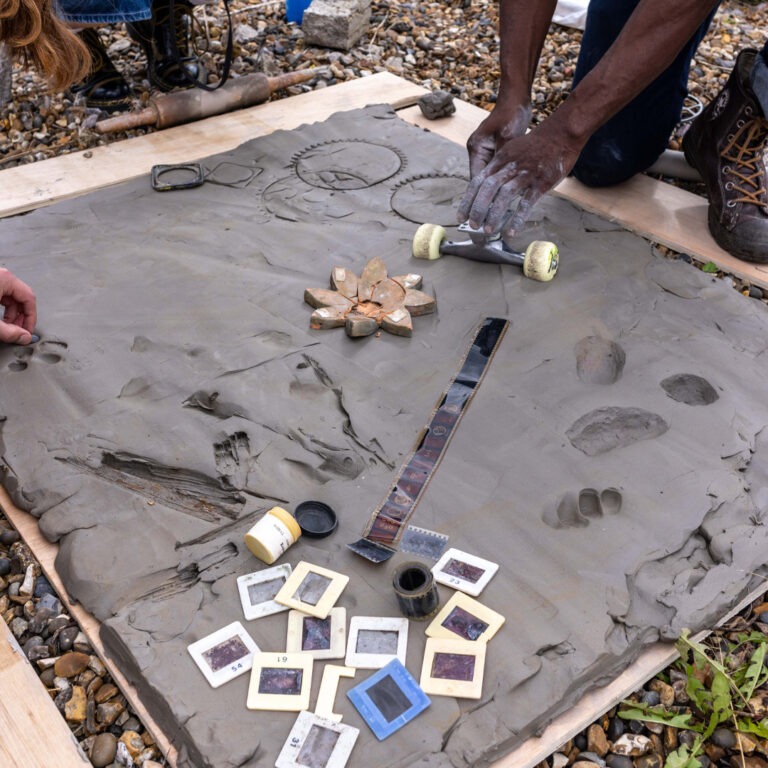 a group of people creating a large collaborative mould