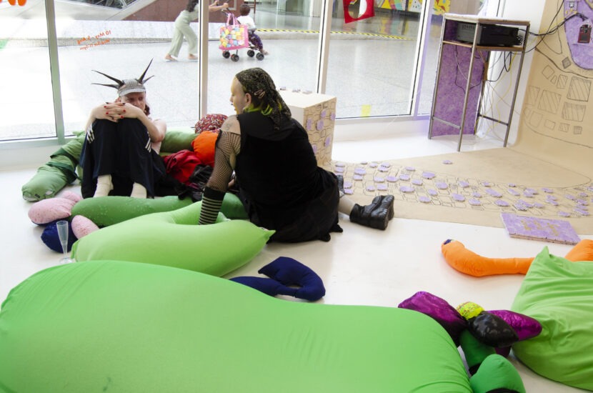 visitors sitting on green beanbags in the gallery