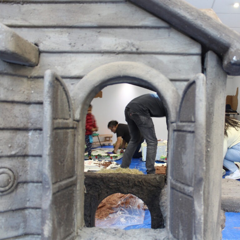 photograph of participants taken through the window of a playhouse