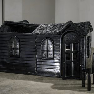 a photograph of a childrens playhouse painted entirely black