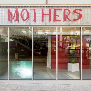 the outside of the turf building with the sign reading "mothers"