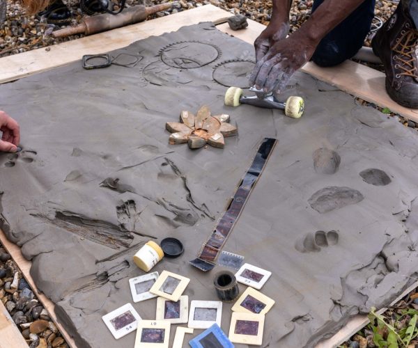 a group of people creating a large collaborative mould