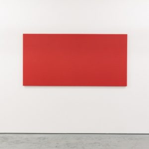 red canvas hung on a white wall