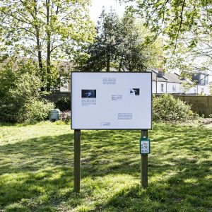 a sign with a range of information displayed in a park