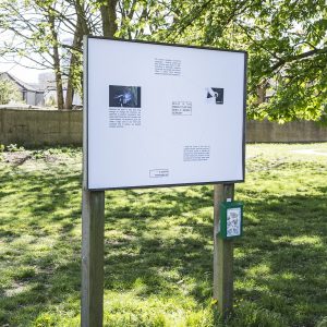 a sign with a range of information displayed in a park