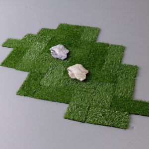 squares of turf with two rocks placed on top