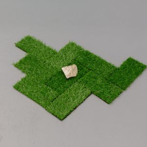 squares of turf with rock placed on top