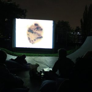 a group of people watching a projected movie