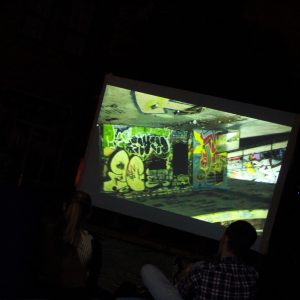 a group of people watching a projected movie